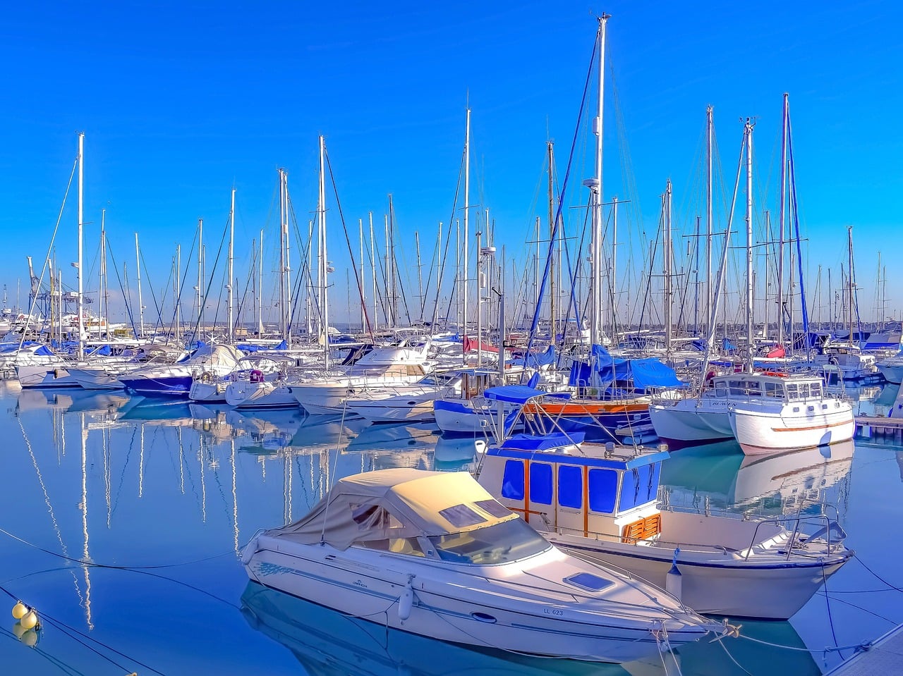 Sailing boats in Larnaca marina under a blue sky