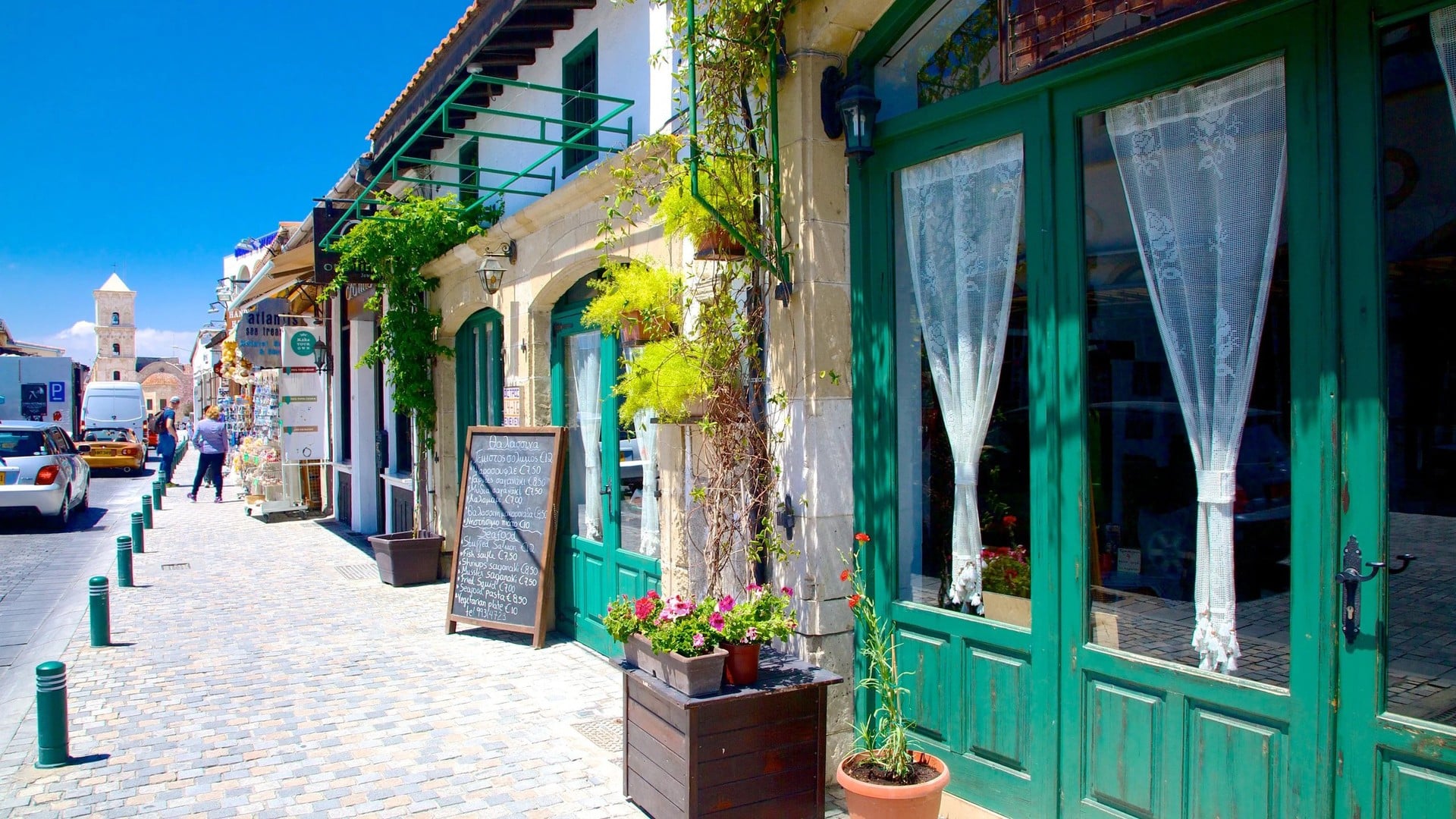 Sunny old town street in Larnaca with the bell tower of Saint Lazarus church