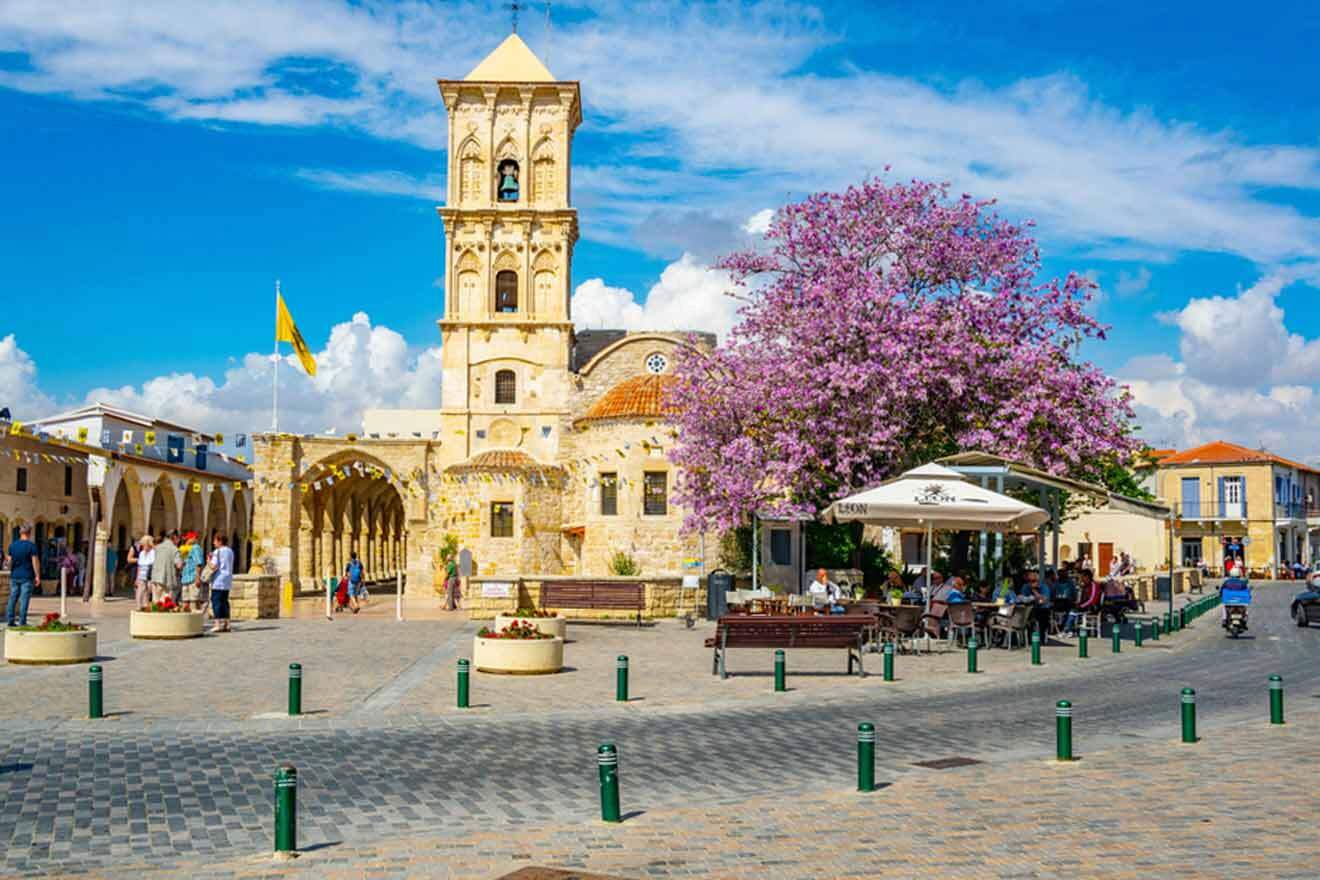 Church of Saint Lazarus with a blooming tree and cafe tables